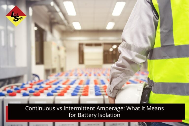 A worker in a high-visibility yellow vest holding a hard hat looking out over rows of industrial batteries in a large facility.